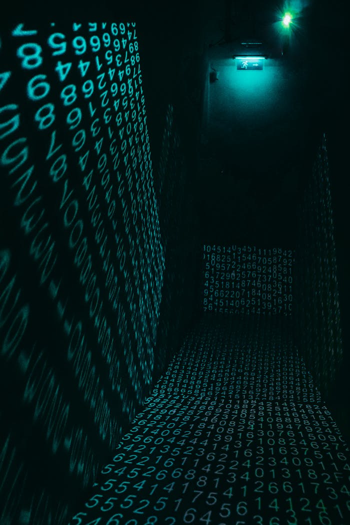 A dark hallway illuminated with neon digital number projections, creating a cyberpunk ambiance.